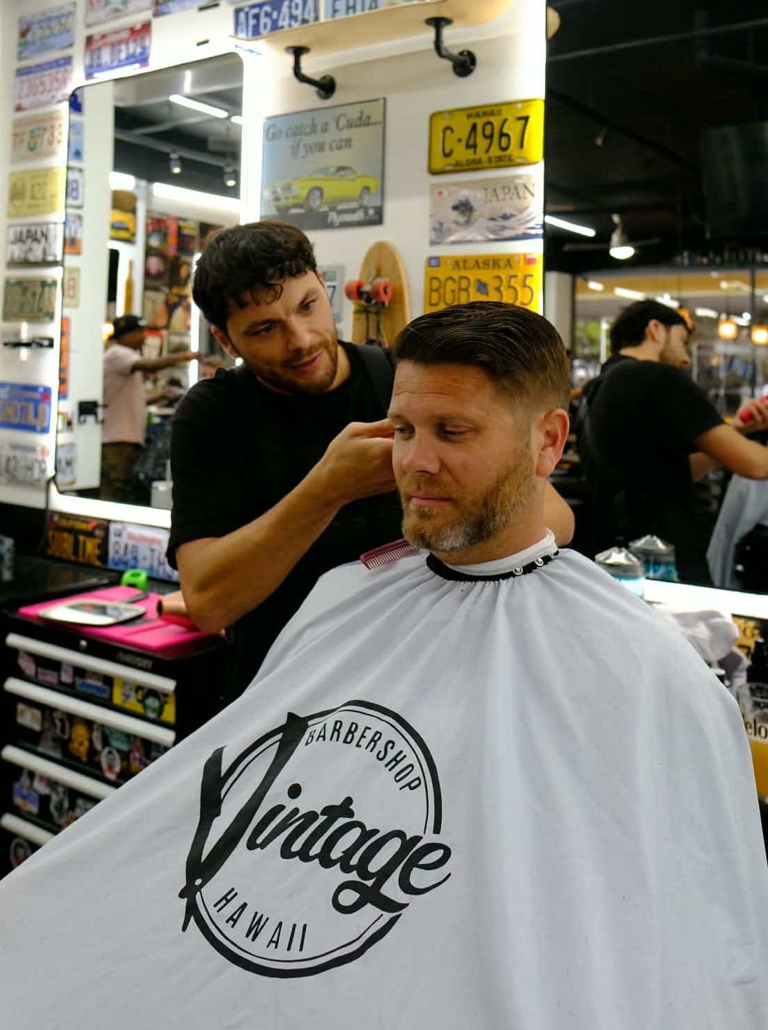 Barber performing a precision haircut at Vintage Barbershop Honolulu